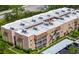 An aerial view of a well-maintained condominium building with lush landscaping and parking at 1540 Glen Oaks E Dr # B336, Sarasota, FL 34232