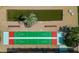 Aerial view of shuffleboard court next to bocce ball, with landscaping in background at 1540 Glen Oaks E Dr # B336, Sarasota, FL 34232