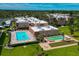 Aerial view showcasing the pool, shuffleboard, bocce ball and well-maintained condo community at 1540 Glen Oaks E Dr # B336, Sarasota, FL 34232