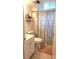 Cozy bathroom with a white toilet, vanity, and a decorative shower curtain at 1540 Glen Oaks E Dr # B336, Sarasota, FL 34232