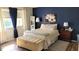 This cozy bedroom has a bed, window, and accent wall at 1540 Glen Oaks E Dr # B336, Sarasota, FL 34232