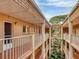 Building exterior featuring covered walkways and lush greenery in the central courtyard at 1540 Glen Oaks E Dr # B336, Sarasota, FL 34232