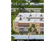 A view of the exterior elevation of the condo building with parking and trees at 1540 Glen Oaks E Dr # B336, Sarasota, FL 34232