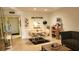 A well-lit living room with a round dining table and tile floors at 1540 Glen Oaks E Dr # B336, Sarasota, FL 34232