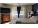 This main bedroom features a dresser, TV, and large window at 1540 Glen Oaks E Dr # B336, Sarasota, FL 34232