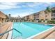 Swimming pool with ample lounge chairs, and buildings in background on sunny day at 1540 Glen Oaks E Dr # B336, Sarasota, FL 34232