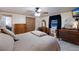 Bedroom with a queen bed, dresser, and ceiling fan at 1640 Center Rd, Terra Ceia, FL 34250