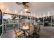 Relaxing screened porch with outdoor dining set and ceiling fan at 1640 Center Rd, Terra Ceia, FL 34250