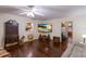 Spacious living area with hardwood floors, a large TV, and views into the kitchen at 1640 Center Rd, Terra Ceia, FL 34250