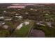 Aerial view of a waterfront property with a modern home and lush surroundings at 1640 Center Rd, Terra Ceia, FL 34250