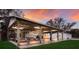 Covered boat storage area with lighting, next to a white detached garage and lush landscaping at 1640 Center Rd, Terra Ceia, FL 34250