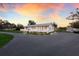 Charming white home with a front porch and well-maintained landscaping at 1640 Center Rd, Terra Ceia, FL 34250