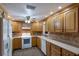 Bright kitchen featuring light wood cabinets, and white appliances at 1640 Center Rd, Terra Ceia, FL 34250