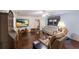 Bright living room featuring hardwood floors, comfy seating, and a large TV at 1640 Center Rd, Terra Ceia, FL 34250