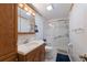 Bathroom with a walk-in shower, vanity, and updated fixtures at 1640 Center Rd, Terra Ceia, FL 34250