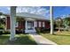 Red building with white trim and walkway, surrounded by palm trees at 1640 Center Rd, Terra Ceia, FL 34250