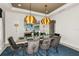Formal dining room with large table, gold light fixtures, and teal accents at 16435 Star Grass Cir, Bradenton, FL 34211