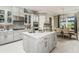 Spacious kitchen boasts an island, white cabinetry, and quartz countertops at 16435 Star Grass Cir, Bradenton, FL 34211
