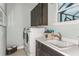 Bright laundry room with front-load washer and dryer, and a utility sink at 16435 Star Grass Cir, Bradenton, FL 34211