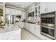 Modern kitchen with white cabinets, stainless steel appliances and quartz countertops at 16435 Star Grass Cir, Bradenton, FL 34211