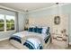 Spacious main bedroom with tufted headboard and elegant lighting at 16435 Star Grass Cir, Bradenton, FL 34211