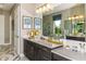 Double vanity bathroom with a large mirror and plenty of counter space at 16435 Star Grass Cir, Bradenton, FL 34211