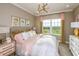 Cozy bedroom with a pink and gold theme at 16435 Star Grass Cir, Bradenton, FL 34211