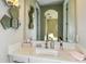 Modern bathroom with quartz countertop and hexagon mirror at 16435 Star Grass Cir, Bradenton, FL 34211