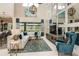 Bright living room with sectional sofa, large windows, and a statement chandelier at 16435 Star Grass Cir, Bradenton, FL 34211