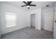 Bedroom with grey carpet, ceiling fan, and a closet at 16801 Celebration Dr, Port Charlotte, FL 33953