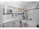 Bathroom with white tile and a tub/shower combination at 2426 Calamonga Ln, Sarasota, FL 34239