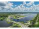 Aerial view of a lake and surrounding landscape at 3124 Sandleheath # 80, Sarasota, FL 34235