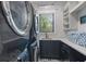 Laundry room with modern washer and dryer, and ample storage at 328 Monroe Dr, Sarasota, FL 34236