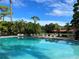 Community pool with plenty of lounge chairs for relaxing at 3711 Pinecone Ct # 168, Sarasota, FL 34238