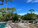Pool area with numerous lounge chairs for sunbathing at 3711 Pinecone Ct # 168, Sarasota, FL 34238