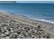 Peaceful beach scene with a pier in the distance at 3711 Pinecone Ct # 168, Sarasota, FL 34238