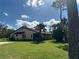 Side view of condo showcasing its tile roof and green lawn at 3711 Pinecone Ct # 168, Sarasota, FL 34238
