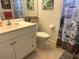 Clean bathroom with white vanity, toilet and tropical shower curtain at 3711 Pinecone Ct # 168, Sarasota, FL 34238