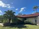 Exterior view of the home with red tile roof and landscaping at 3711 Pinecone Ct # 168, Sarasota, FL 34238