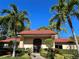 Community clubhouse with Spanish tile roof and landscaping at 3711 Pinecone Ct # 168, Sarasota, FL 34238