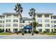 Condo building showcasing attractive exterior and landscaping at 3808 Gulf Of Mexico Dr # E307, Longboat Key, FL 34228