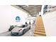 High-ceiling garage with cars, motorcycles, and stairs at 3866 Clover Ln, Sarasota, FL 34233