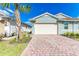 Exterior view showing the garage and a brick driveway at 387 Ibiza Loop, Venice, FL 34292