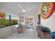 Sunroom with glass table and chairs, access to patio at 4573 Pine Green Trl # 1, Sarasota, FL 34241