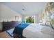 Main bedroom featuring a king-size bed, dresser, and large window with garden view at 4573 Pine Green Trl # 1, Sarasota, FL 34241