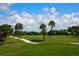 Scenic golf course with palm trees and cart path at 4573 Pine Green Trl # 1, Sarasota, FL 34241