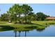 Golf course with water feature and players at 4573 Pine Green Trl # 1, Sarasota, FL 34241