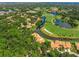 Aerial view showing houses, lakes, and a golf course in a community at 4573 Pine Green Trl # 1, Sarasota, FL 34241