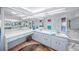 Double vanity bathroom with large mirrors and light-colored cabinets at 4573 Pine Green Trl # 1, Sarasota, FL 34241