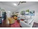 Open concept living room with hardwood floors and plenty of natural light at 4573 Pine Green Trl # 1, Sarasota, FL 34241